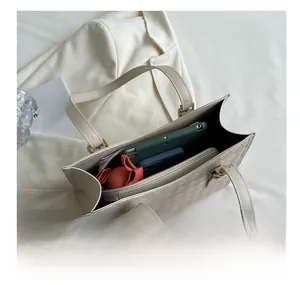 Detail of the spacious interior compartment with zip pocket in a quilted tote bag