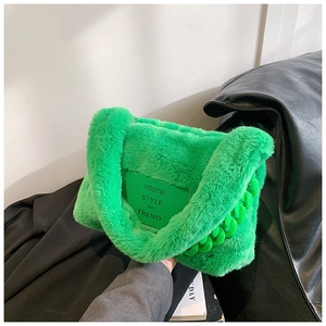 Detail of green faux fur tote with Youth Style patch and chunky acrylic chain strap