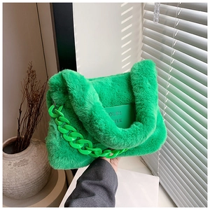 Detail of bright green faux fur tote bag with chunky plastic chain and logo plaque