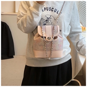 Close-up of pink floral patchwork bucket bag with metal chain strap and turn-lock clasp