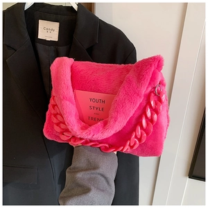 Detail of hot pink faux fur tote bag featuring a chunky chain and Y2K style text print