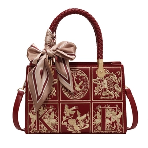 Elegant red PU leather crossbody bag with floral embroidery and decorative silk scarf