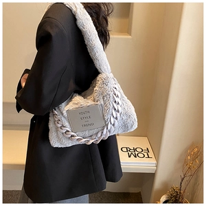 Detail of grey faux fur tote featuring chunky plastic chain and Youth Style logo tag