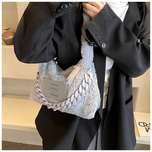 Detail of grey faux fur tote bag with lavender chunky chain strap for winter style
