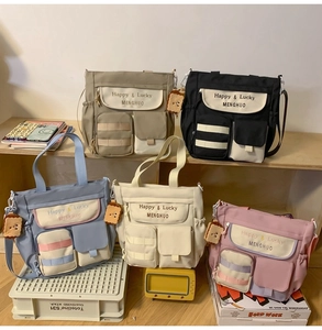 Detailed display of assorted large capacity nylon tote bags in five versatile colors