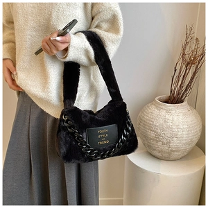 Close-up of fluffy black tote bag featuring chain detail and youth style leather patch