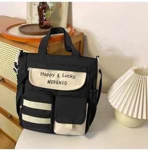 Detail view of contrast Oxford tote with multi-pocket storage and adjustable strap