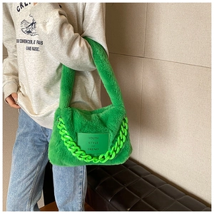 Detail of green faux fur tote bag with chunky plastic chain and Youth Style patch