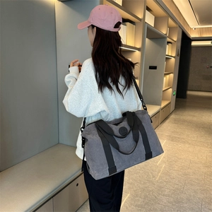 Grey canvas large capacity travel bag with top handles and adjustable shoulder strap