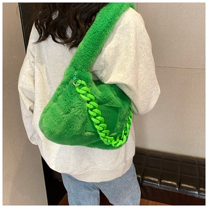 Close-up of bright green faux fur shoulder bag with plastic chain and Youth Style label