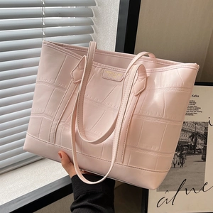 Pink faux leather tote bag with crocodile pattern and dual handles for daily commute