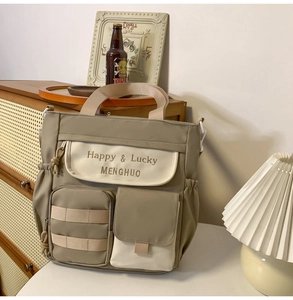 Detail of multi-pocket oxford tote bag with drawstring closure and handle in khaki