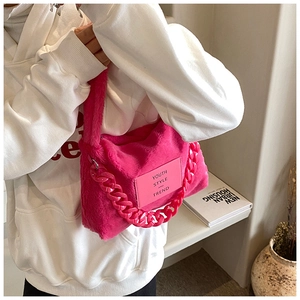 Detail of pink faux fur tote bag showing plush texture, chic chain, and brand label