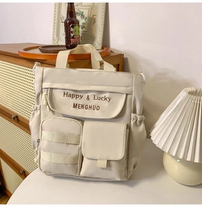 Close-up of functional pockets and embroidery on beige Oxford fabric tote bag