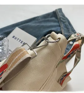 Detailed macro view of high-quality silver metal hardware on a canvas tote bag
