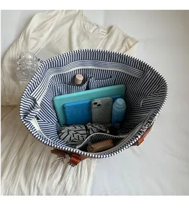 Interior view of straw tote bag showing large capacity for tablet and essentials