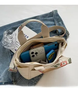 Detail view of large canvas tote bag interior with multiple storage compartments