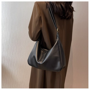 Chic black leather hobo shoulder bag with vertical stitching detail on model back
