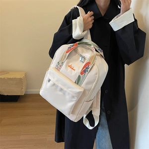 Sac à dos femme beige minimaliste avec poignée tissée colorée et logo brodé orange