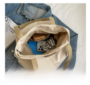 Interior view of large capacity canvas tote bag showing storage for daily essentials