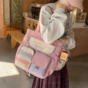 Pink multi-pocket Oxford tote bag with plush toast charm for daily commuting and crossbody use