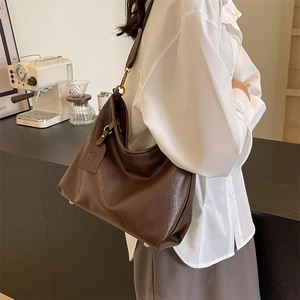 Brown leather large capacity hobo bag with vintage gold buckle and round logo charm