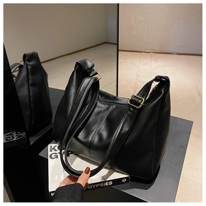 Detailed view of black soft leather bag with premium texture and vintage gold buckle