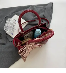 Interior view of the red crossbody bag showing spacious storage and inner zipper pocket