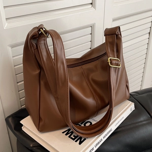 Brown large capacity hobo dumpling bag in premium textured leather with gold metal buckle