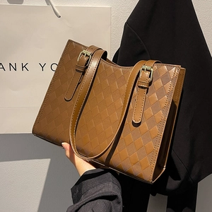 Brown quilted tote bag with adjustable straps and gold hardware for stylish commuting