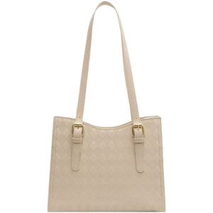 Beige faux leather tote bag with diamond quilted pattern and gold buckle shoulder strap