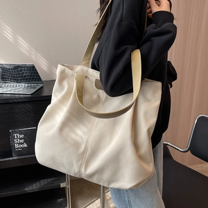 Large cream canvas tote bag with brown straps for commuting and daily casual use