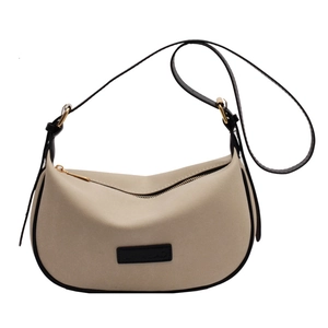 Chic beige crossbody dumpling bag with black leather contrast trim and gold zipper