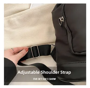 Detail of adjustable nylon shoulder strap and silver metal buckle on the black backpack