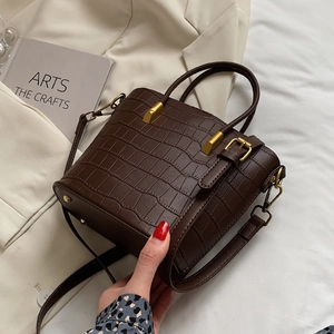 Dark brown crocodile embossed leather bucket bag with gold hardware and top handle