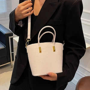 White crocodile-embossed bucket bag with gold hardware and top handles for women