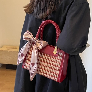 Fashionable red leather square handbag with houndstooth pattern and scarf detail