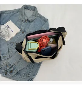 Top view of beige nylon crossbody bag showcasing spacious interior with daily essentials