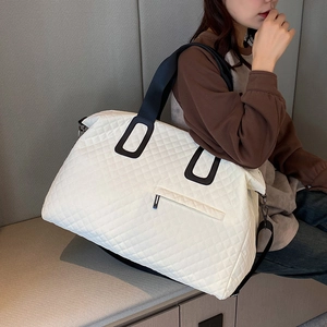 White quilted travel tote bag with large capacity and black wide strap handles