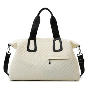 Quilted oversized travel tote bag in contrast cream and black with adjustable straps