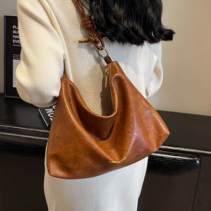Retro brown oversized shoulder bag in oil-wax leather with unique knot strap detail