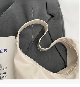 Detailed macro view of cream PU leather texture and silver zipper on crescent bag