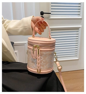 Detail of pink bucket bag with 3D white flower embroidery and adjustable shoulder strap