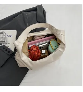 Top view of spacious interior of off-white tote bag holding umbrella and laptop