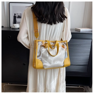 Detail view of transparent jelly tote bag with yellow trim and inner pouch on model