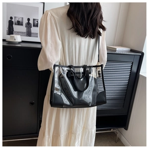 Detailed view of clear PVC tote bag with black trim and matching inner pouch strap