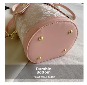 Detail view of pink leather and lace bucket bag with gold anti-wear bottom rivets