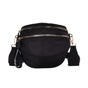 Minimalist black nylon crossbody bag with dual golden zippers and fashion strap