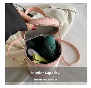 Internal capacity of pink bucket bag showing storage for phone, umbrella and cosmetics