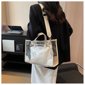 Detail of transparent PVC jelly tote bag with inner pouch and wide woven shoulder strap